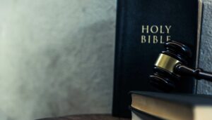 Gavel falling in front of a holy bible.